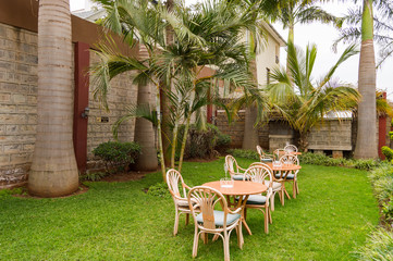 Sleeping corner with three iron chairs in a tropical garden in Nairobi Kenya