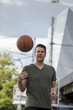 © Nektarstock - Man Holding Basketball in an Urban Setting
