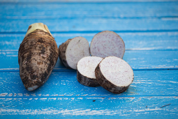 Wall Mural - Group of Taro Root on wooden Background