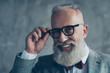 © deagreez - Close up portrait of cheerful affable stylish trendy rich intelligent smart dreamy professional elegant excited elite luxurious old-fashioned grandpa trying on new glasses isolated on grey background
