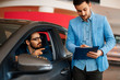 © djile - Young man choosing new car for buying in dealership shop
