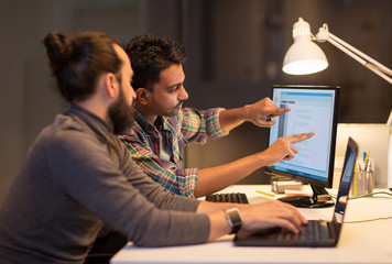 creative team with computer working late at office