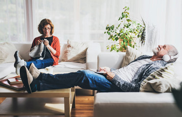 Wall Mural - Senior couple relaxing at home.