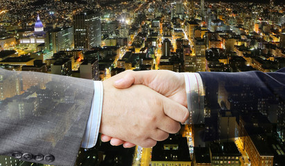 Aufkleber - Closeup of business people handshake on big city at night background 