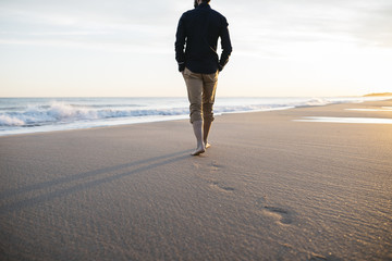 walking on beach at sunset