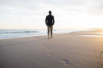 walking on beach at sunset