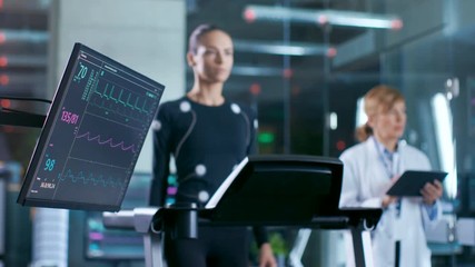Wall Mural - monitor showing ekg reading of a woman athlete walking on a treadmill in the background, specialist 