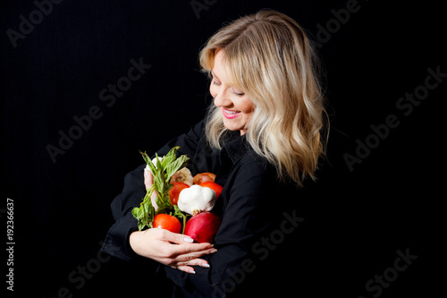 Fotografie, Obraz Woman Holding Italian Vegetables On A Black Background