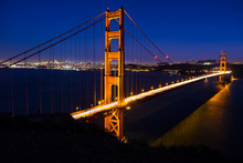 Illuminated Golden Gate Bridge Over Bay Of Water Against Sky