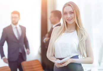 portrait of an elegant young business woman on the office backgr