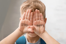 Little Boy With Words "Stop Bullying" On Light Background