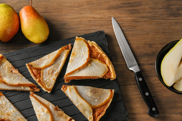 Sticker - Slices of delicious pear tart on wooden board