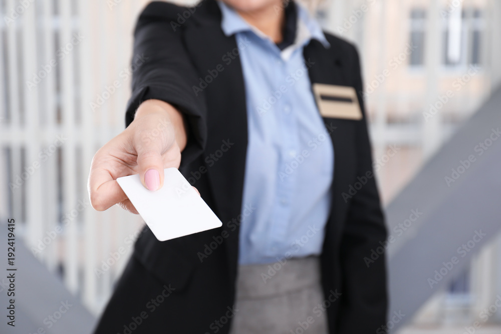 Female receptionist with card in hotel