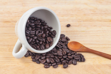 coffee beans in white cup on wood table