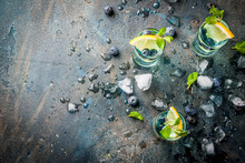 Summer Refreshment Drinks, Blueberry Lemonade Or Mojito Cocktail With Lemon, Fresh Blueberries And Mint, Sdark Blue Stone Background Copy Space Top View