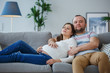 © Sergey - Image of pregnant woman and man on gray sofa