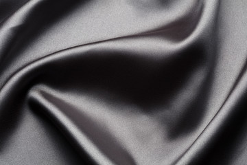 Abstract, elegant background texture with waves of silk, satin luxury cloth fabric