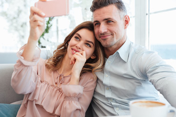 Poster - Portrait of a happy young couple taking a selfie