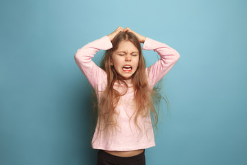 The cry. Teen girl on a blue background. Facial expressions and people emotions concept