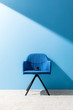 © LIGHTFIELD STUDIOS - cup of delicious coffee on chair in front of blue wall