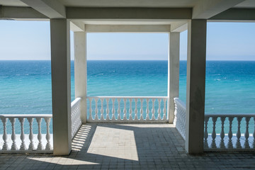 White gazebo on the waterfront with seascape view