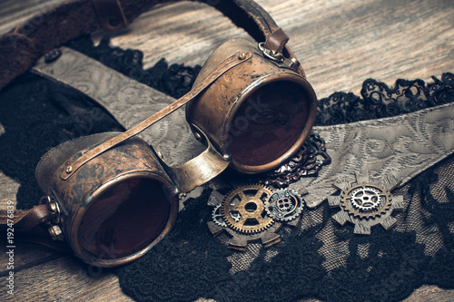 A beautiful still-life in the steampunk style with protective goggles and accessories of women's clothing Fotobehang
