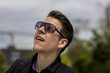 © Nektarstock - Headshot of Man With Sunglasses Looking Up at the Sky