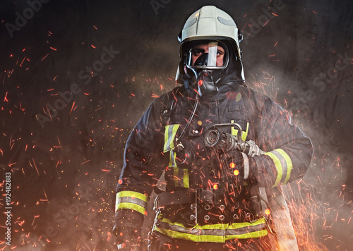 Photographie A firefighter dressed in a uniform in a studio.