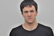 © sergiy1607 - portrait of a frowning young man on a white background