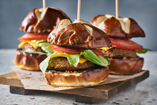 Three Vegan Burger Sliders With Pretzel Buns