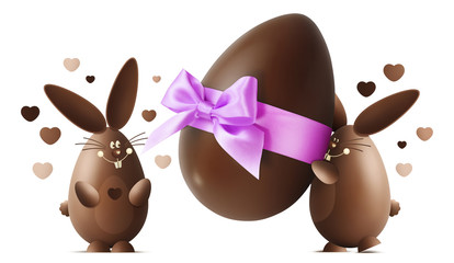 Wall Mural - Chocolate Easter bunnies with egg and pink ribbon bow isolated on white background