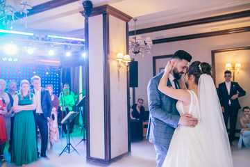 First dance the bride and groom in the smoke. brides wedding party in the elegant restaurant with a wonderful light and atmosphere