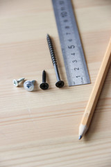 Working process. Screws, ruler, pencil.