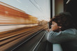 © RooM The Agency - Close-up of a young Boy leaning on a window sill Looking Through a Train Window