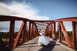 wedding couple on the bridge with metal architecture