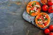 Spicy hummus mini flat breads with tomatoes and feta. Flat lay, side orientation on a dark background, Healthy eating concept.