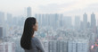 © leungchopan - Woman looking at the city view