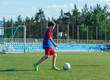 © Natali - boy trains dribbling on the summer stadium during the training