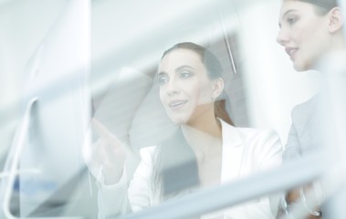 Poster - behind the glass.business team sitting at Desk