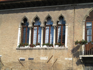 Vintage window and detail of a classical building in the historical center of Venezia.