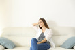 © Antonioguillem - Woman resting in a couch with copy space above