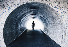 Man walking in tiled tunnel