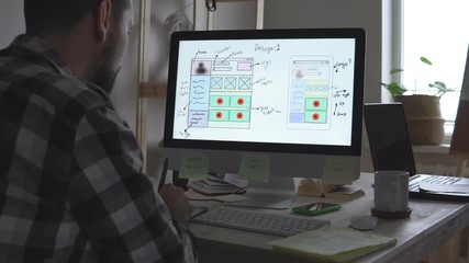 The site developer makes sketches of the future site. Working remotely from a home office.