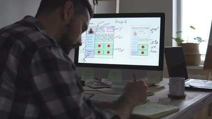 The site developer makes sketches of the future site. Working remotely from a home office.