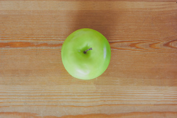 Green apple on a wooden background