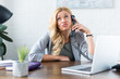 irritated businesswoman talking by telephone in office