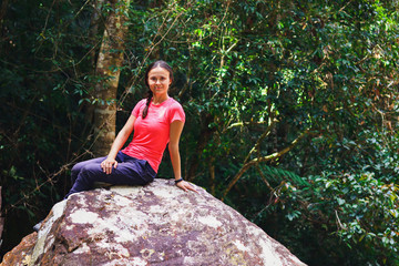 Tourist sit on dry waterfall stones