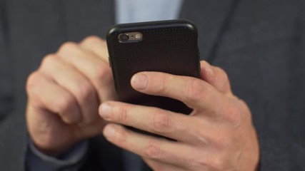 Hands typing sms message on smartphone.