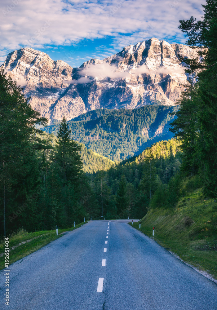 Dolomite Alps in Italy. Beautiful day. The road passes in the ...
