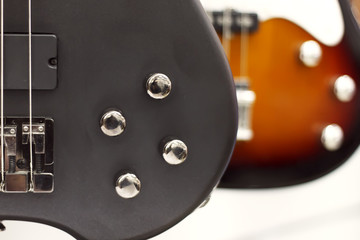 Electric guitar close-up with a soft focus of black color, tone controls, volume.